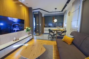 a living room with a couch and a table at Mia's Modern Mountain in Kolašin