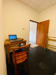 a laptop computer sitting on a desk in a room at m&s villa in Weligama