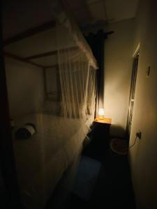 a bedroom with a bed with a white mosquito net at m&s villa in Weligama +18 photos