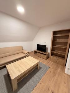 a living room with a couch and a tv at Workhome A2 zu 6 in Lünen