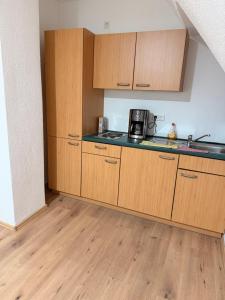 a kitchen with wooden cabinets and a counter top at Workhome A2 zu 6 in Lünen