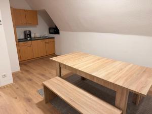 a kitchen with a wooden table in a room at Workhome A2 zu 6 in Lünen +4 photos