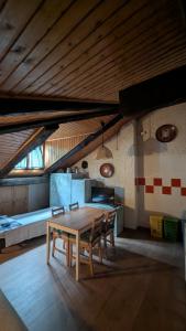 a dining room with a table and chairs in a room at Mansarda 2 in Commezzadura +6 photos