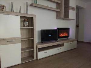 a living room with a tv and a fireplace at Cambrils Beach in Cambrils