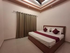 a bedroom with a large bed with a curtain at Vamika Palace in Ayodhya