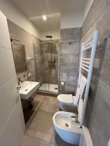 a bathroom with a sink and a toilet and a shower at Maqueda Suites in Palermo +16 photos