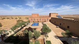 an aerial view of a building with a swimming pool at Itrane sahara Auberge in Taouz