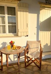 a table and a chair on a patio at Katastega Tinos in Istérnia +9 photos
