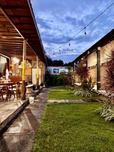 a patio with a table and chairs in a yard at Sudi Guest House in Pemuteran