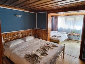 a bedroom with two beds with towels on them at Old House - Стара Къща in Koprivshtitsa +36 photos