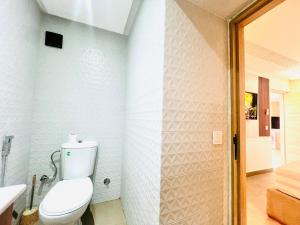 a white bathroom with a toilet and a shower at Lovely studio 4th floor No Elevator in El Gouassem +12 photos