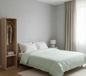 a white bedroom with a large bed and a window at Norvia Otel in Konya