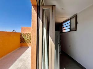 an open door to a balcony with a window at Lovely studio 4th floor No Elevator in El Gouassem