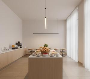 a kitchen with a table with a bowl of fruit on it at Norvia Otel in Konya