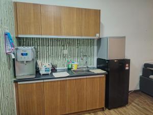 a kitchen with a sink and a refrigerator at Suria jaya studio condo shah alam in Shah Alam +7 photos