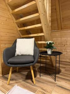 a chair sitting next to a table with a plant at Cottage Soul Rest in Visoko