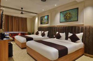 a hotel room with two beds in a room at Hotel Maya Cottage' Newly Rebuilt 2026' Near New Delhi Railway Station & Connaught place in New Delhi +34 photos