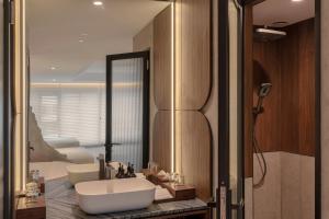 a bathroom with a white tub and a sink at The Cara Hotel in Kota Kinabalu +17 photos