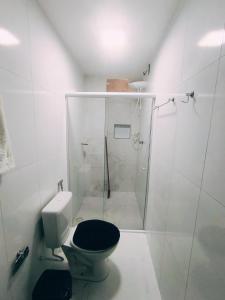 a white bathroom with a toilet and a shower at Bella Morena 3 - Ilha de Boipeba in Cairu +7 photos