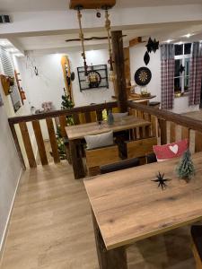 a dining room with wooden tables and chairs at Schrammi's Ferienwohnung in Schwanau