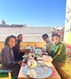 a group of people sitting around a table with food at NUB Guest House in Aswan