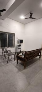 a living room with two benches and a table at The Loft OMR in Chennai