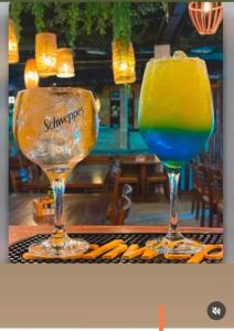 two glasses sitting on a table with a drink at Bella Morena 3 - Ilha de Boipeba in Cairu