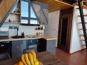 a kitchen with a table with bananas on it at SUNSET Villa PONIKVA in Kočani