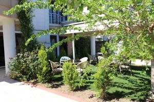 a patio with tables and chairs in front of a building at Asfar Villa in Yalova