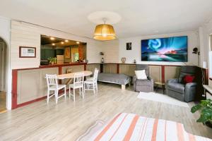 un soggiorno con un tavolo e una cucina di Gemütliche Ferienwohnung in Nordschweden a Glommersträsk