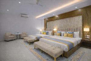 a large bedroom with two beds and a couch at Hotel The Prithvi Near Delhi Airport in New Delhi +207 photos