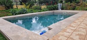 a swimming pool with blue water in a yard at House with a heated pool for your exclusive use in Santa Brígida