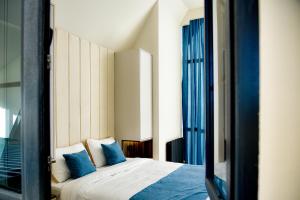 a bedroom with a bed with blue pillows at Arinest Villa with heated pool, 20 min from Yerevan in Elar +70 photos