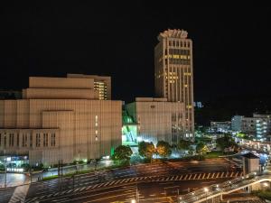 a city skyline with tall buildings at night at Mercure Yokosuka in Yokosuka
