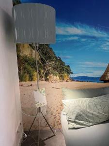 a bedroom with a bed and a lamp on a beach at Moderne Unterkunft mit Wellnessflair in Bodelshausen