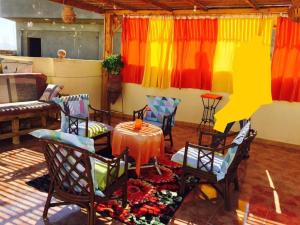 a room with colorful curtains and a table and chairs at Sphinx in Al Karnak