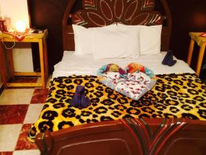 a bedroom with a bed with two hearts on it at Sphinx in Al Karnak