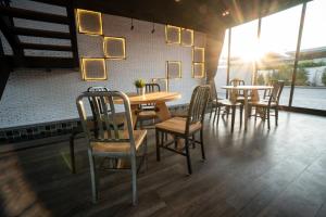 a group of tables and chairs in a restaurant at The Brick Huahin Pool Villa in Hua Hin