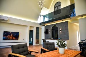 a living room with a table and chairs at Arinest Villa with heated pool, 20 min from Yerevan in Elar