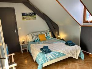 a bedroom with a bed with towels on it at La maison Bellevue in Antignac