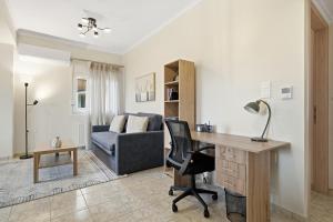 a living room with a desk and a couch at Calma Ioannina Apartment in Ioannina