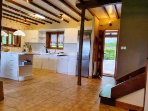 a large kitchen with white cabinets and a large refrigerator at Villa Elorrio in Elorrio