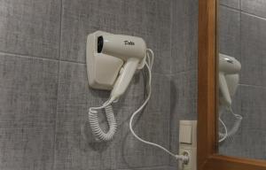 a phone hanging on a wall in a bathroom at Nabada Hotel - Riverside in Ozurgetʼi