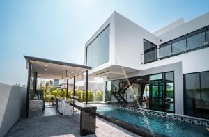 an exterior view of a house with a swimming pool at The Brick Huahin Pool Villa in Hua Hin