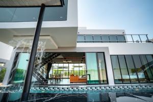 an external view of a building with a swimming pool at The Brick Huahin Pool Villa in Hua Hin