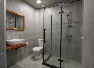 a bathroom with a shower and a toilet and a sink at Nabada Hotel - Riverside in Ozurgetʼi +28 photos