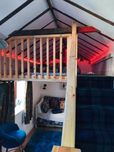 a bedroom with a bunk bed in a room at Zanders cave in Edwinstowe