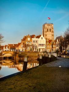 a city with a building and a bridge and water at B&B Röderhaus Guesthouse Goedereede in Goedereede