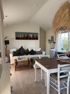 a living room with a couch and a table at Ferienhaus Breskens in Breskens