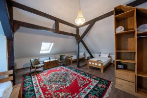 a living room with a red rug on the floor at Doa Boutique Hotel in Peje